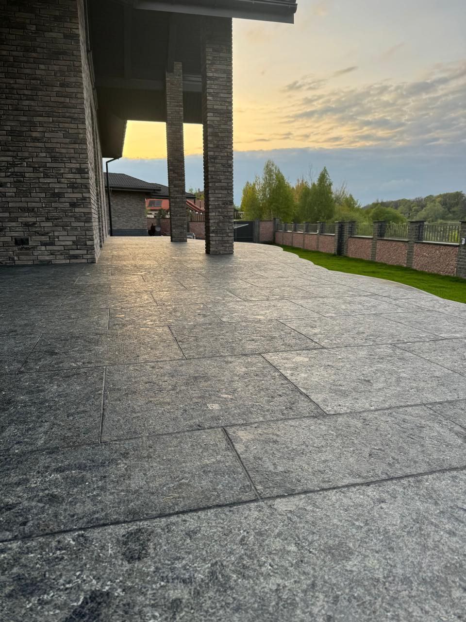 Beautiful patio with Black Ice L7 Labradorite granite pavers at sunset