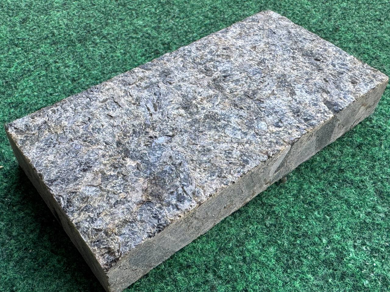 Single Black Ice L7 paver on green turf