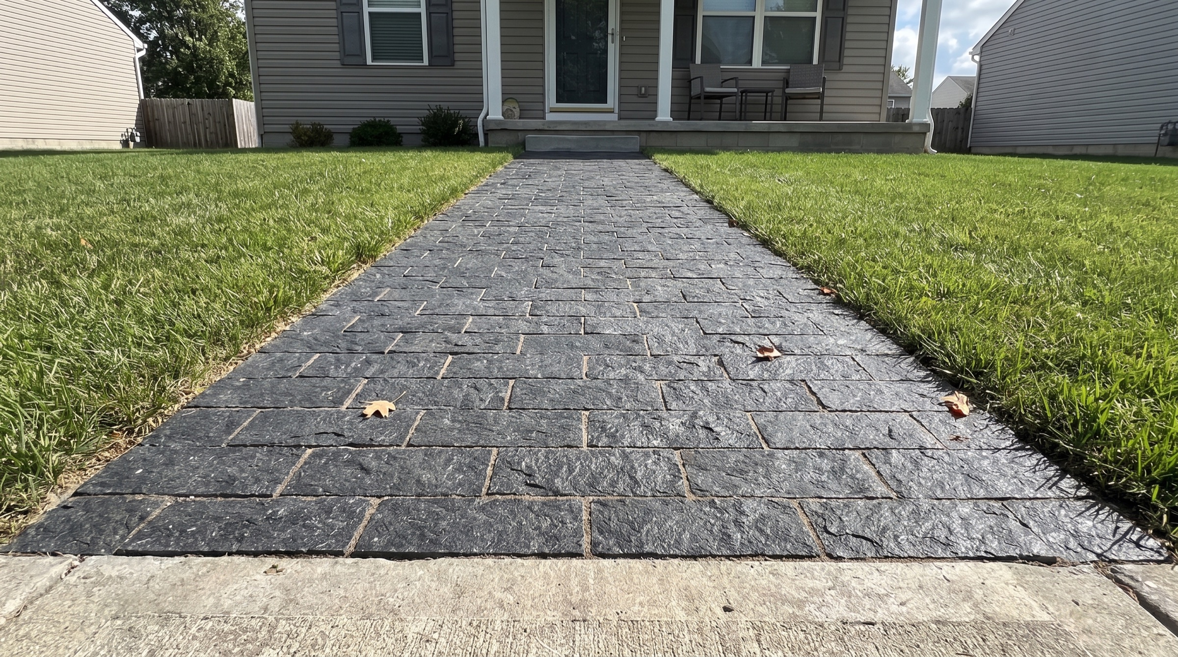 Dark splitface granite pavers laid as a walkway
